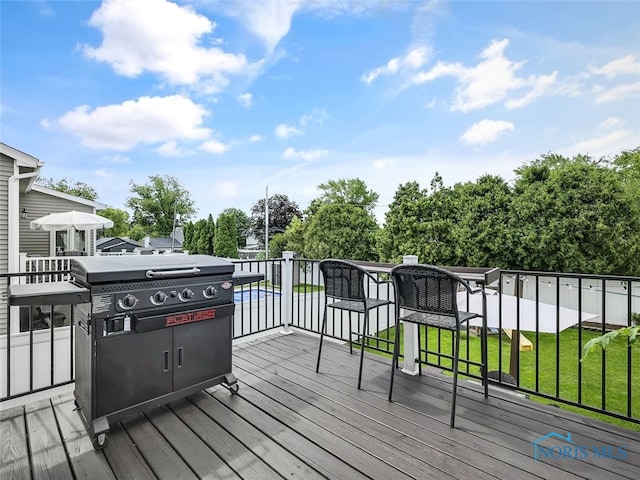 5425 Tulane Ave, Toledo, OH 43611 - wooden deck with grilling area, a yard, and view of wooded area