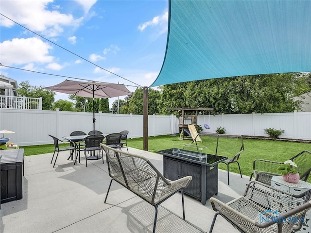 5425 Tulane Ave, Toledo, OH 43611 - fenced backyard featuring outdoor dining space, a patio, and a playground