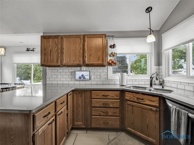 5425 Tulane Ave, Toledo, OH 43611 - kitchen featuring dishwasher, tasteful backsplash, a peninsula, brown cabinetry, and a textured ceiling