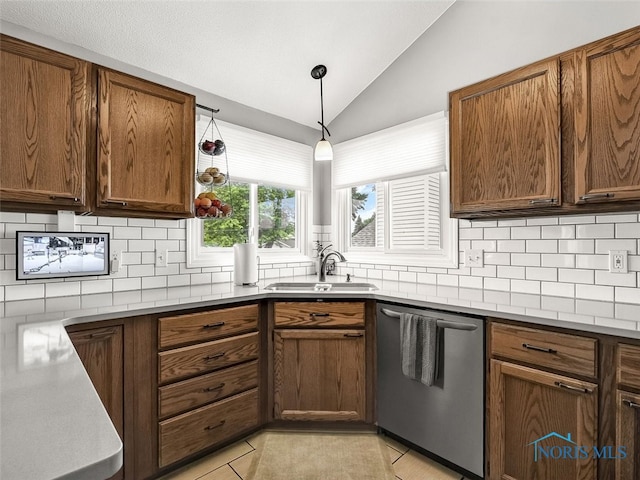 5425 Tulane Ave, Toledo, OH 43611 - kitchen featuring dishwasher, vaulted ceiling, tasteful backsplash, light tile patterned flooring, and brown cabinets
