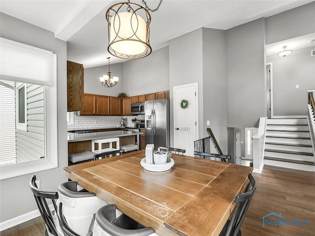 5425 Tulane Ave, Toledo, OH 43611 - dining space with a chandelier, dark wood-style floors, stairs, and high vaulted ceiling