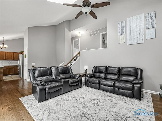 5425 Tulane Ave, Toledo, OH 43611 - living room with ceiling fan, dark wood-style floors, stairs, and a chandelier