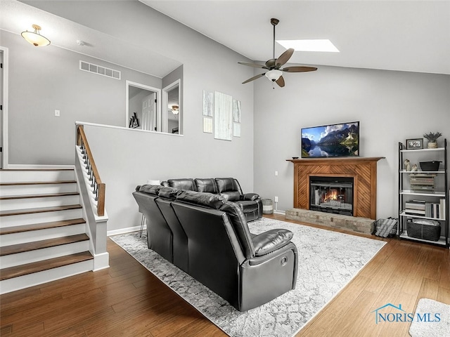 5425 Tulane Ave, Toledo, OH 43611 - living room with ceiling fan, stairway, a brick fireplace, wood finished floors, and vaulted ceiling