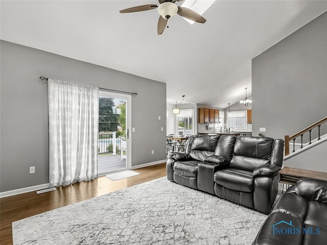5425 Tulane Ave, Toledo, OH 43611 - living area featuring lofted ceiling, a ceiling fan, wood finished floors, and a chandelier