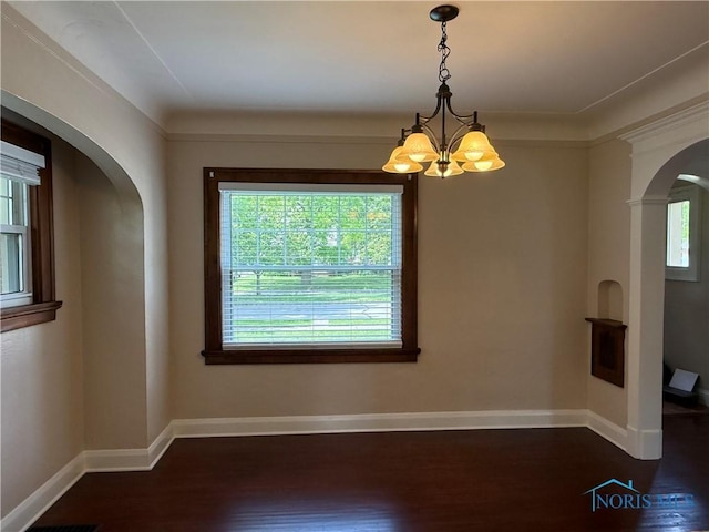 733 Mayfair Blvd, Toledo, OH 43612 - spare room with arched walkways, dark wood-style floors, and a chandelier
