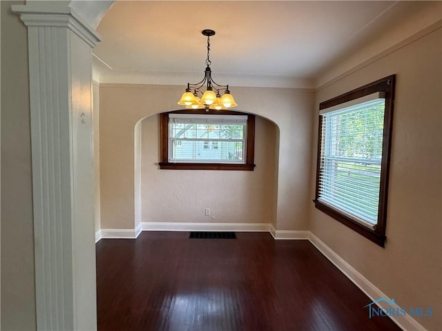 733 Mayfair Blvd, Toledo, OH 43612 - unfurnished dining area featuring arched walkways, a chandelier, and dark wood finished floors
