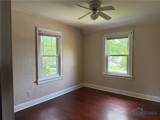 733 Mayfair Blvd, Toledo, OH 43612 - unfurnished room with healthy amount of natural light, a ceiling fan, dark wood-style floors, and vaulted ceiling