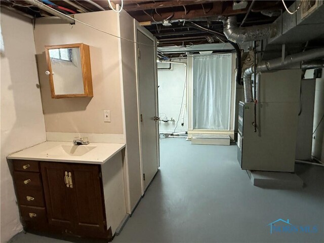 733 Mayfair Blvd, Toledo, OH 43612 - unfinished basement featuring a sink and heating unit