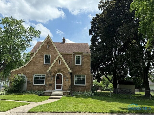 733 Mayfair Blvd, Toledo, OH 43612 - tudor house with brick siding, a chimney, and a shingled roof