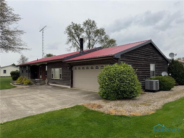 12401 County Highway 110, Upper Sandusky, OH 43351 - view of front facade with concrete driveway, a metal roof, and an attached garage