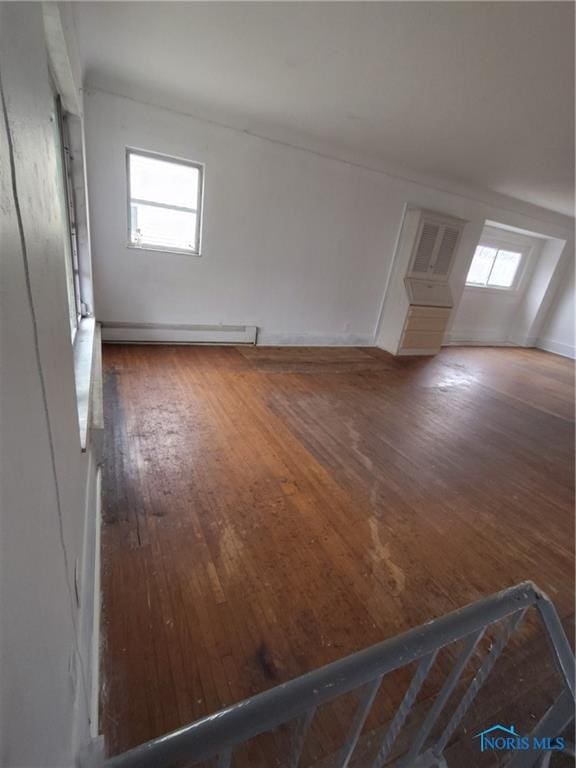 4625 Lewis Ave, Toledo, OH 43612 - unfurnished living room with a baseboard radiator, wood-type flooring, and plenty of natural light