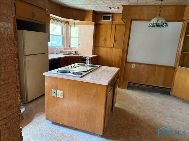 4625 Lewis Ave, Toledo, OH 43612 - kitchen featuring freestanding refrigerator, electric stovetop, tile countertops, wood walls, and brown cabinets