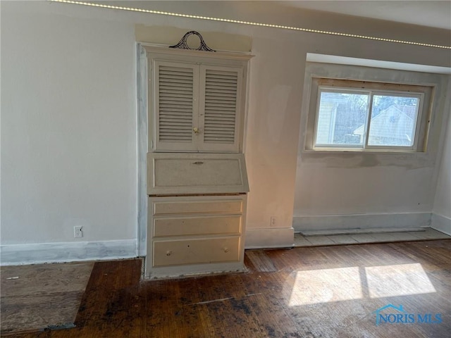 4625 Lewis Ave, Toledo, OH 43612 - unfurnished bedroom featuring dark wood-type flooring and baseboards