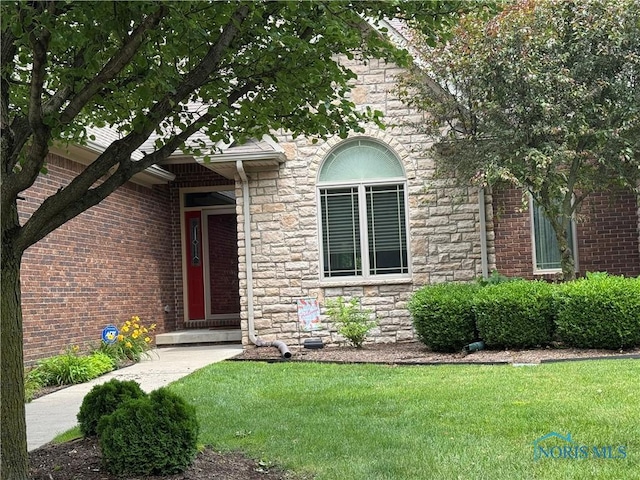 5346 Palisades Dr, Sylvania, OH 43560 - view of front facade with stone siding and a front lawn
