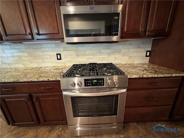 5346 Palisades Dr, Sylvania, OH 43560 - kitchen featuring appliances with stainless steel finishes, tasteful backsplash, and light stone countertops