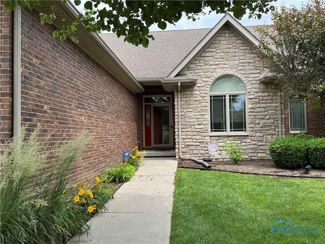 5346 Palisades Dr, Sylvania, OH 43560 - entrance to property with stone siding, a shingled roof, a yard, and brick siding