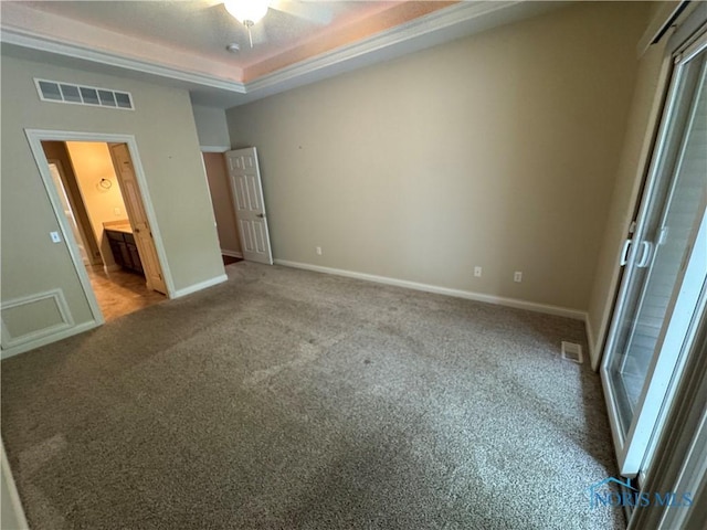 5346 Palisades Dr, Sylvania, OH 43560 - unfurnished bedroom with carpet floors, a tray ceiling, and ensuite bath