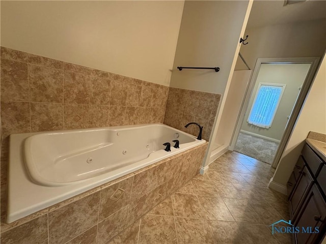 5346 Palisades Dr, Sylvania, OH 43560 - bathroom with vanity, a tub with jets, and tile patterned floors