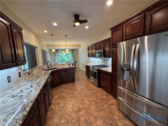 5346 Palisades Dr, Sylvania, OH 43560 - kitchen with stainless steel appliances, backsplash, ceiling fan, dark brown cabinets, and recessed lighting