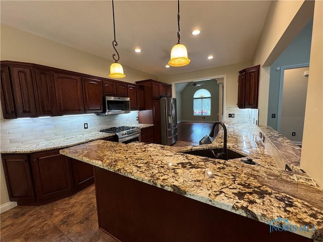 5346 Palisades Dr, Sylvania, OH 43560 - kitchen featuring appliances with stainless steel finishes, ceiling fan, tasteful backsplash, a peninsula, and light stone countertops