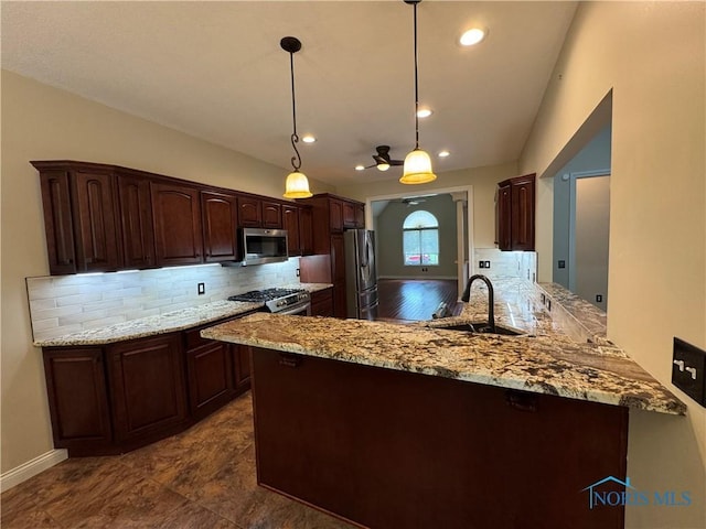 5346 Palisades Dr, Sylvania, OH 43560 - kitchen featuring stainless steel appliances, decorative backsplash, dark brown cabinetry, a peninsula, and light stone countertops