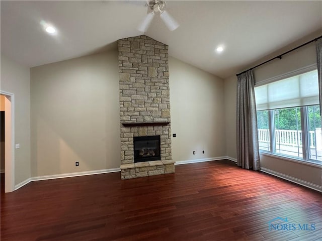 5346 Palisades Dr, Sylvania, OH 43560 - unfurnished living room with wood finished floors, a ceiling fan, vaulted ceiling, and a stone fireplace
