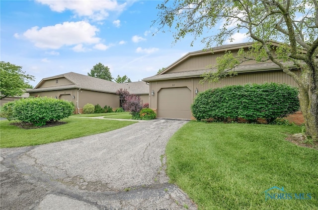 11 Meadowpond Dr, Perrysburg, OH 43551 - view of front of house featuring an attached garage, asphalt driveway, and a front lawn