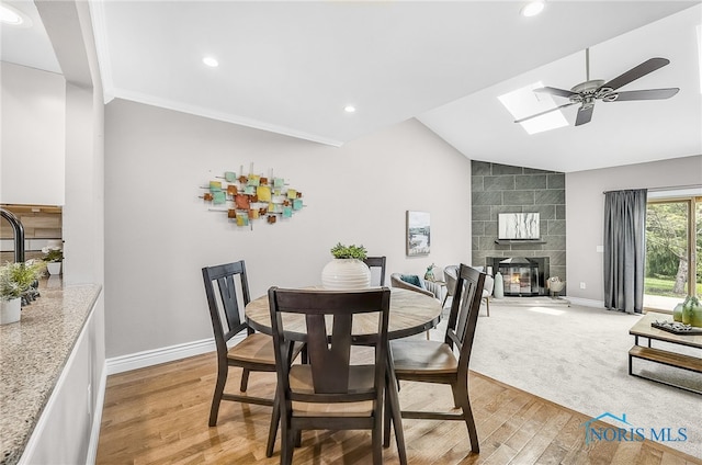 11 Meadowpond Dr, Perrysburg, OH 43551 - dining space featuring lofted ceiling, light wood-style floors, a ceiling fan, a skylight, and recessed lighting