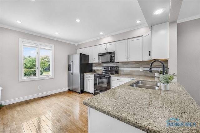 11 Meadowpond Dr, Perrysburg, OH 43551 - kitchen featuring black appliances, crown molding, light stone counters, decorative backsplash, and white cabinets