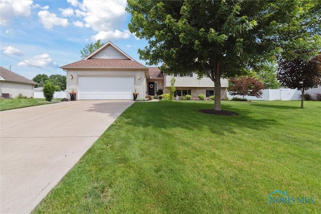 735 Hemlock St, Wauseon, OH 43567 - split level home with a garage and concrete driveway