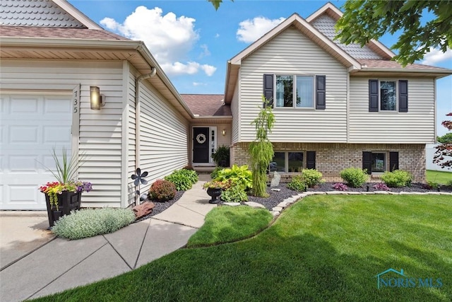 735 Hemlock St, Wauseon, OH 43567 - split level home with a garage, a front lawn, and a shingled roof