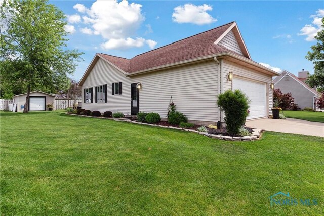735 Hemlock St, Wauseon, OH 43567 - view of side of property featuring a lawn, concrete driveway, roof with shingles, and an attached garage