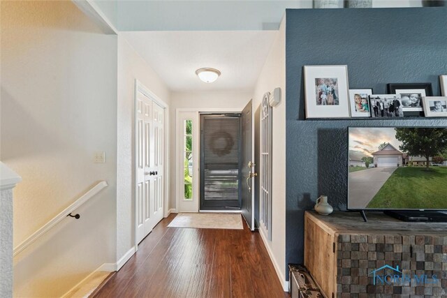 735 Hemlock St, Wauseon, OH 43567 - entrance foyer with dark wood-style flooring and baseboards
