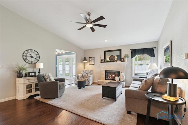 735 Hemlock St, Wauseon, OH 43567 - living room featuring lofted ceiling, dark wood-style flooring, healthy amount of natural light, a fireplace, and a ceiling fan