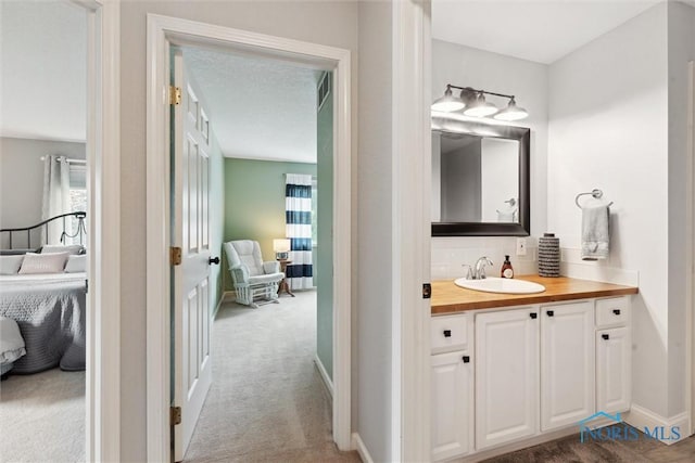 735 Hemlock St, Wauseon, OH 43567 - bathroom featuring vanity, ensuite bath, and backsplash