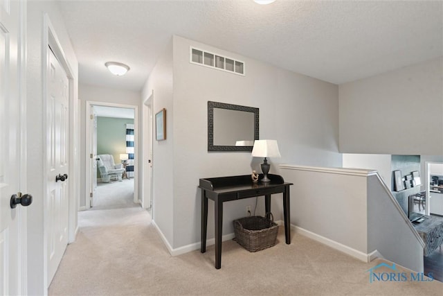 735 Hemlock St, Wauseon, OH 43567 - hallway with an upstairs landing, carpet flooring, and a textured ceiling