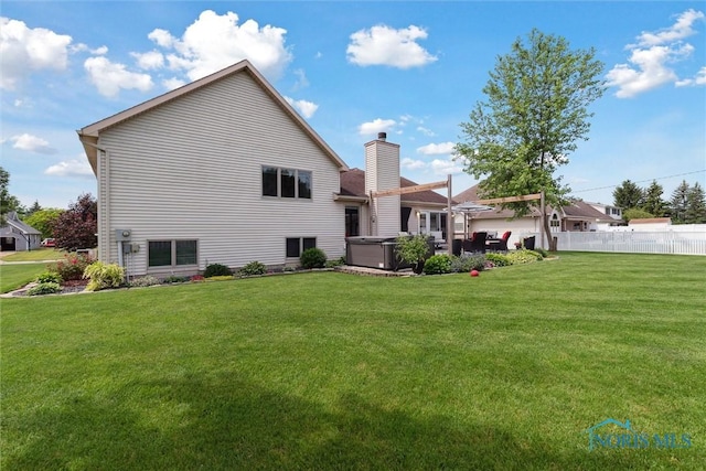 735 Hemlock St, Wauseon, OH 43567 - back of property with a hot tub and a chimney