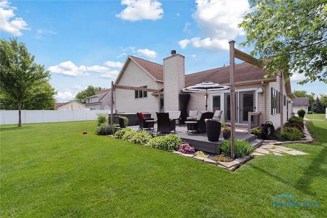 735 Hemlock St, Wauseon, OH 43567 - back of property with an outdoor hangout area, a chimney, a shingled roof, and a deck