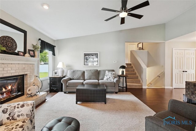 735 Hemlock St, Wauseon, OH 43567 - living room with vaulted ceiling, wood finished floors, ceiling fan, a fireplace, and stairway