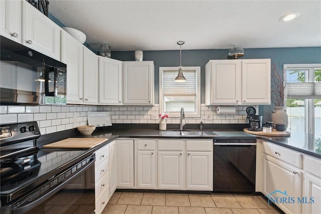735 Hemlock St, Wauseon, OH 43567 - kitchen featuring black appliances, dark countertops, white cabinets, and recessed lighting