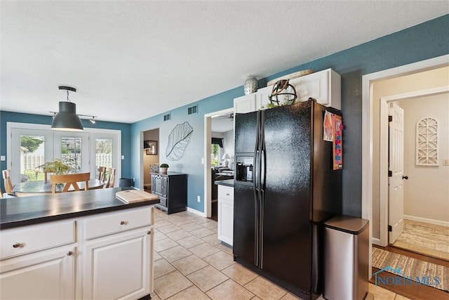 735 Hemlock St, Wauseon, OH 43567 - kitchen featuring black fridge with ice dispenser, dark countertops, white cabinetry, decorative light fixtures, and light tile patterned floors