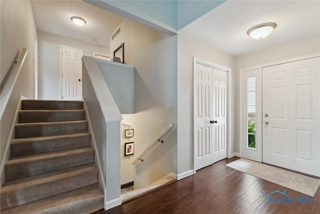 735 Hemlock St, Wauseon, OH 43567 - foyer entrance with dark wood-style floors and stairs