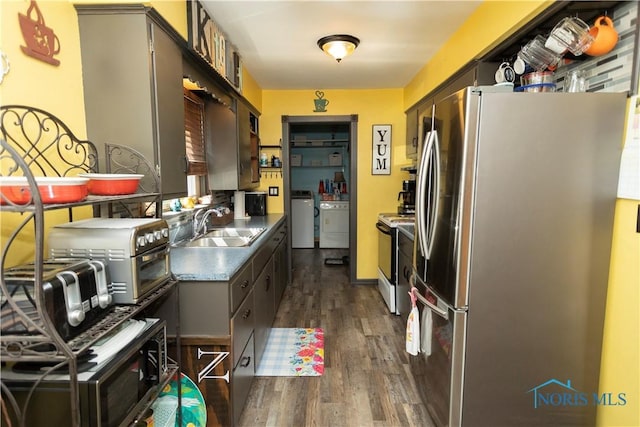 1118 5th St, Findlay, OH 45840 - kitchen with freestanding refrigerator, washer and dryer, electric stove, and dark wood-style floors