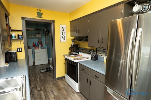 1118 5th St, Findlay, OH 45840 - kitchen featuring freestanding refrigerator, electric range, separate washer and dryer, dark wood-type flooring, and under cabinet range hood