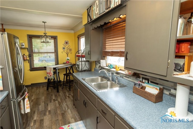 1118 5th St, Findlay, OH 45840 - kitchen with freestanding refrigerator, dark wood-type flooring, decorative light fixtures, a chandelier, and light countertops