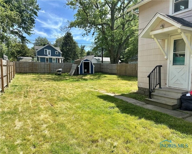 228 Harris St, Elmore, OH 43416 - fenced backyard with entry steps and a storage unit
