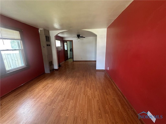 228 Harris St, Elmore, OH 43416 - unfurnished room featuring arched walkways, wood finished floors, and ceiling fan