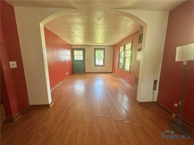 228 Harris St, Elmore, OH 43416 - empty room featuring light wood finished floors and arched walkways