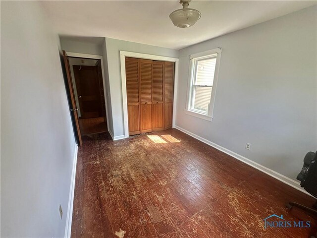 228 Harris St, Elmore, OH 43416 - unfurnished bedroom featuring a closet and wood finished floors