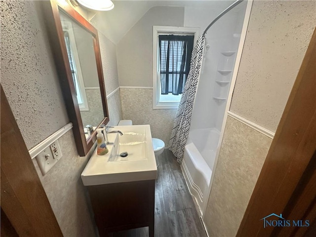 228 Harris St, Elmore, OH 43416 - bathroom featuring wood finished floors, lofted ceiling, a wainscoted wall, shower / bath combination with curtain, and vanity